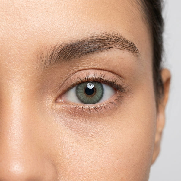 Orama Glassy Green colored contact lens shown on a single eye