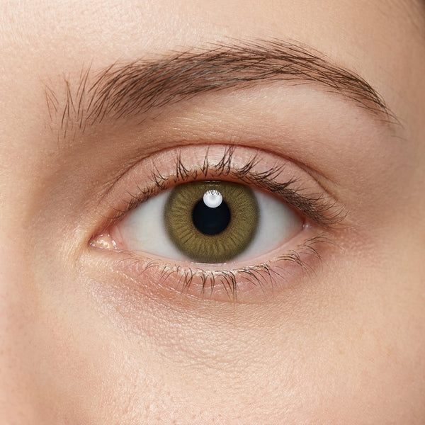 Orama Amber Wood colored contact lens shown on a single eye