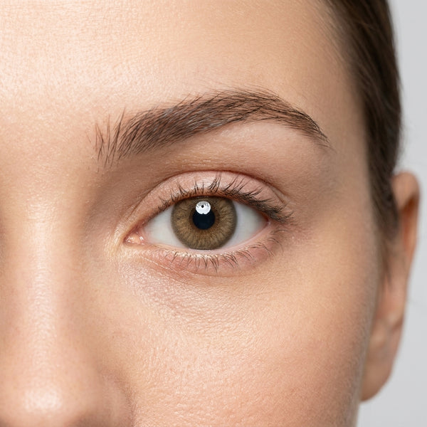 Orama Autumn Hazel colored contact lens shown on a single eye