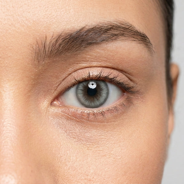 Orama Gray Wood colored contact lens shown on a single eye